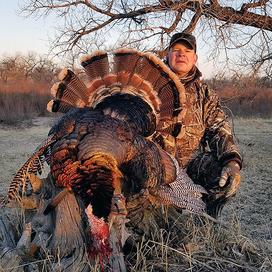 Me and my 23lb spring Merriam's turkey.  He is headless because I decided to buy a PatternMaster Code Black Turkey for my Benelli SBE 3 and at 25 yards, it was absolutely lethal with one shot. Couldn't believe the difference your choke tube made!